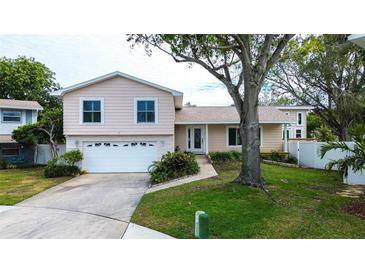 Two-story house with attached garage and landscaped lawn at 12430 81St Pl, Seminole, FL 33772