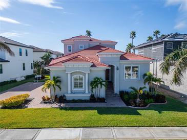 Two-story house with a red tile roof, white columns, and lush landscaping at 1308 Alhambra Dr, Apollo Beach, FL 33572