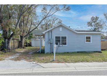 Gray house with a detached garage, and a small front yard at 1575 S Martin Luther King Jr Ave, Clearwater, FL 33756