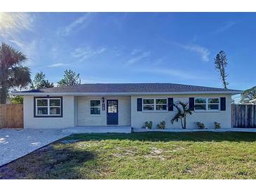 Newly renovated single story home with modern facade, new landscaping, and driveway at 1709 Marilyn Ave, Bradenton, FL 34207