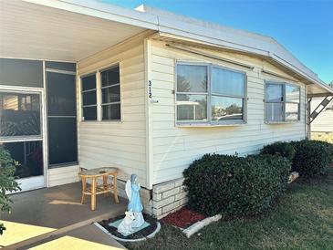 Mobile home exterior with landscaping and screened porch at 9790 66Th N St # 312, Pinellas Park, FL 33782