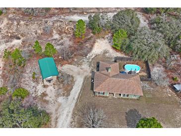 Aerial view of house, pool, and shed at 12404 Dolquieb Ln, Weeki Wachee, FL 34614