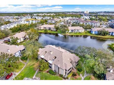 Aerial view of condo community with lake, pool, and lush landscaping at 10265 Gandy N Blvd # 1507, St Petersburg, FL 33702
