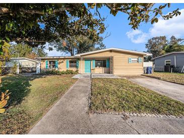 Ranch-style home with a spacious yard and a long driveway at 415 Country Club Dr, Oldsmar, FL 34677