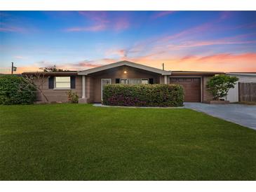 Charming ranch home with well-manicured lawn and attached garage at 5147 Perennial Dr, Holiday, FL 34690