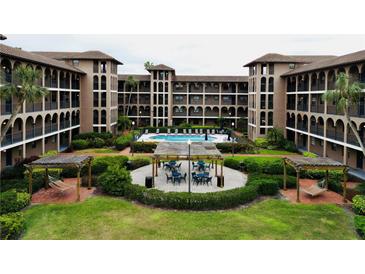 Courtyard view of condo building with pool and seating area at 6100 Gulfport S Blvd # 214, Gulfport, FL 33707