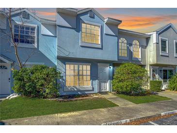 Inviting exterior of a light blue townhome with landscaping at 6781 121St Ave # F, Largo, FL 33773