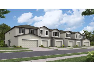 New townhouses with attached garages and landscaping at 13252 Empress Jewel Trl, Parrish, FL 34219