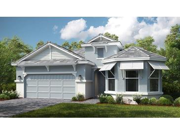 Two-story home with light blue siding, gray roof, and a two-car garage at 5531 Orsello St, Palmetto, FL 34221