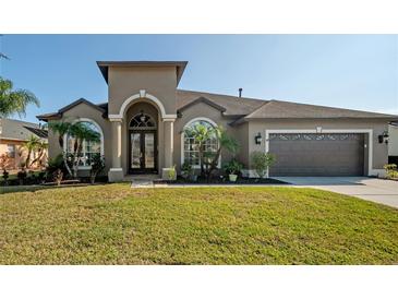 Beautiful one-story home with a two-car garage and manicured lawn at 10126 Londonshire Ln, Tampa, FL 33647