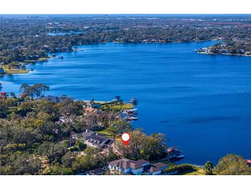 Property location shown from above, situated on a lakefront lot at 11710 N Armenia Ave, Tampa, FL 33612
