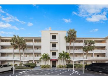 Attractive condo building with ample parking and lush landscaping at 1524 Lakeview Rd # 305, Clearwater, FL 33756