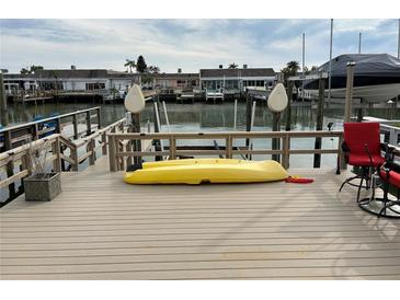 Private dock with kayak and seating, offering waterfront access at 322 Boca Ciega Point N Blvd, St Petersburg, FL 33708