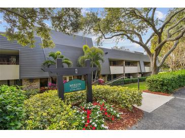 Exterior view of Merion Lodge, showcasing manicured landscaping and building entrance at 36750 Us Highway 19 N # 13301, Palm Harbor, FL 34684