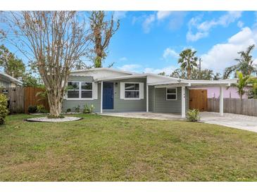 Charming green house with a well-manicured lawn and a modern facade at 5144 13Th S Ave, Gulfport, FL 33707