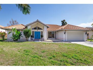 Single-story home with terracotta roof, attached garage, and landscaped lawn at 2250 Rio De Janeiro Ave, Punta Gorda, FL 33983