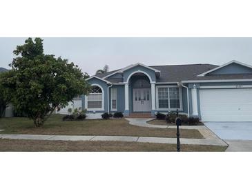 Curb appeal abounds at this charming one-story home featuring a two-car garage at 23917 Pow Wow Dr, Lutz, FL 33559