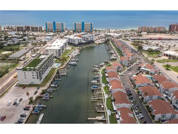 Aerial view of waterfront community with marina, pool, and recreational areas at 320 Medallion Blvd # D, Madeira Beach, FL 33708