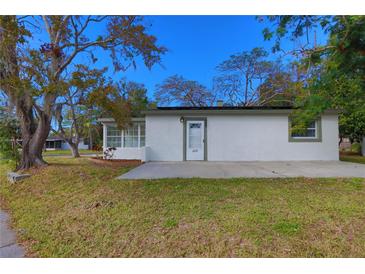 Updated bungalow home exterior with a white facade, new landscaping, and a spacious yard at 6699 78Th N Ave, Pinellas Park, FL 33781