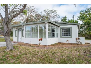 Newly renovated home with a sunroom and a landscaped front yard at 6699 78Th N Ave, Pinellas Park, FL 33781