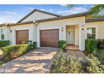 Two-unit home with two-car garages and landscaping at 10374 Echo Dock Loop, San Antonio, FL 33576