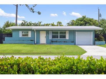 Ranch style home with a carport and a well-maintained lawn at 3064 Pinetree St, Port Charlotte, FL 33952