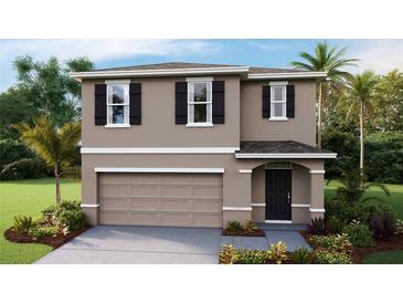 Two-story house with neutral siding, two-car garage, and landscaping at 36055 Sunflower Hill Dr, Zephyrhills, FL 33541