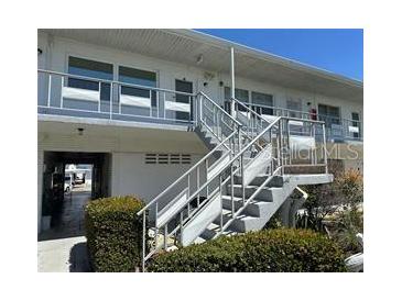 Clean exterior of condo building with stairs and landscaping at 5915 18Th N St # 12, St Petersburg, FL 33714