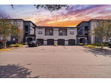 Two-story building with attached garages and parking at 8517 Island Breeze Ln # 207, Temple Terrace, FL 33637