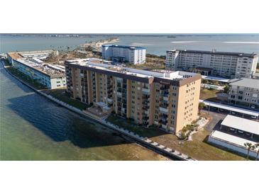 Aerial view of waterfront condo building with parking and water access at 9 Haig Pl # 707, Dunedin, FL 34698