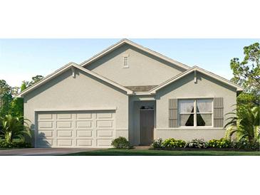 Single-story house with light-grey siding, shutters, and a two-car garage at 32722 Osprey Peak Way, San Antonio, FL 33576