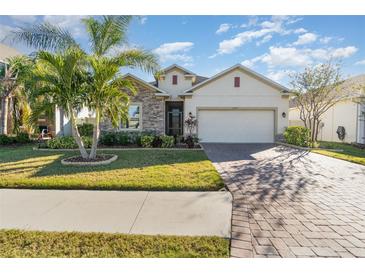 Beautiful one-story home with stone accents and a large driveway at 3409 77Th E Ct, Palmetto, FL 34221