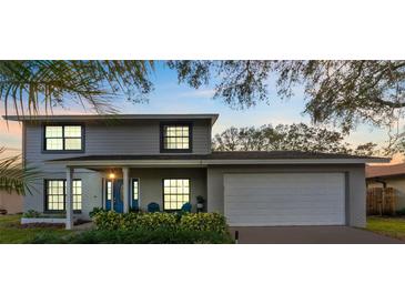 Two-story house with gray siding, blue door, and attached garage at 16013 Eagle River Way, Tampa, FL 33624