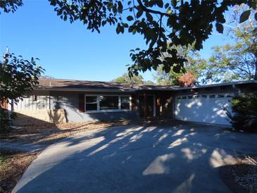 Ranch-style home with attached garage and driveway at 1824 Southwood Ln, Clearwater, FL 33764