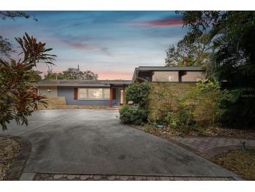 Ranch style home with circular driveway and mature landscaping at 1824 Southwood Ln, Clearwater, FL 33764