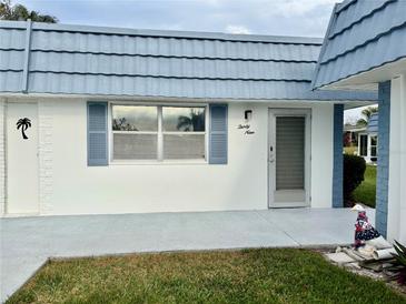 Exterior view of condo showing front entrance, landscaping, and building features at 1901 Andover Way # 39, Sun City Center, FL 33573