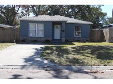 Cute bungalow with gray exterior, stone accents, and a driveway at 4684 25Th S Ave, St Petersburg, FL 33711