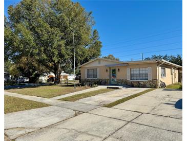Ranch style home with mature landscaping and a spacious driveway at 4825 Sierra Madre Dr, Tampa, FL 33634