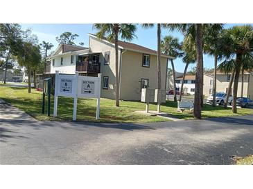 Exterior view of condo building with landscaping and parking at 22481 Westchester Blvd # A23, Punta Gorda, FL 33980