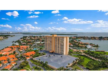 Aerial view of a waterfront highrise building with parking and surrounding landscape at 4900 Brittany S Dr # 409, St Petersburg, FL 33715
