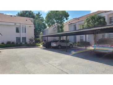 Covered parking area with several cars parked under the carport at 4745 Puritan Cir # 4745, Tampa, FL 33617