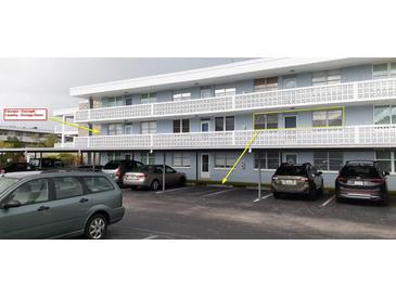 Parking lot view of condo building with covered parking and ample spaces at 4895 Bay Ne St # 211, St Petersburg, FL 33703