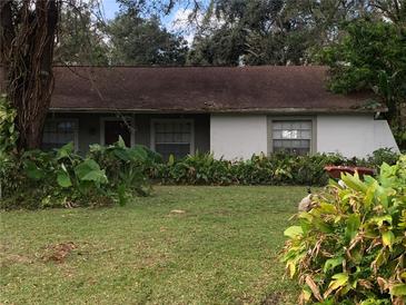 Ranch-style home with mature landscaping and a brown roof at 5824 58Th Street Ct, Tampa, FL 33619