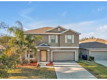 Two-story house with a two-car garage and landscaping at 8506 Hunters Fork Loop, Ruskin, FL 33573