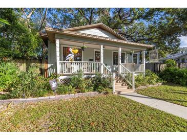 Charming bungalow with a welcoming front porch and manicured lawn at 1155 Crescent Lake N Dr, St Petersburg, FL 33701