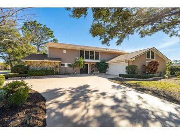 Two-story house with stone accents and a large driveway at 2781 Westchester Dr S, Clearwater, FL 33761