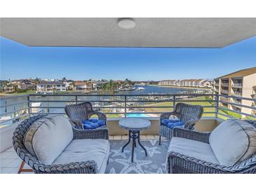 Enjoy breathtaking water views from this relaxing balcony, complete with comfortable seating at 2795 Kipps Colony S Dr # 305, St Petersburg, FL 33707