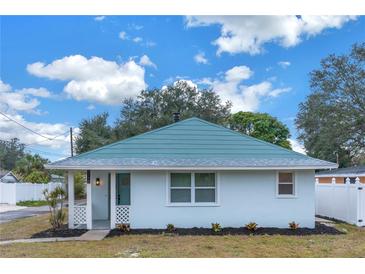Newly renovated single story home with teal roof and white exterior at 5718 Magnolia N St, St Petersburg, FL 33703