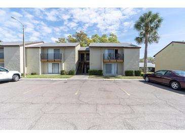 Condo building exterior with parking and palm trees at 4215 E Bay Dr # 1702A, Clearwater, FL 33764