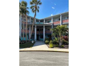 Brick building exterior with palm trees and a walkway at 4300 58Th N St # 2000, Kenneth City, FL 33709